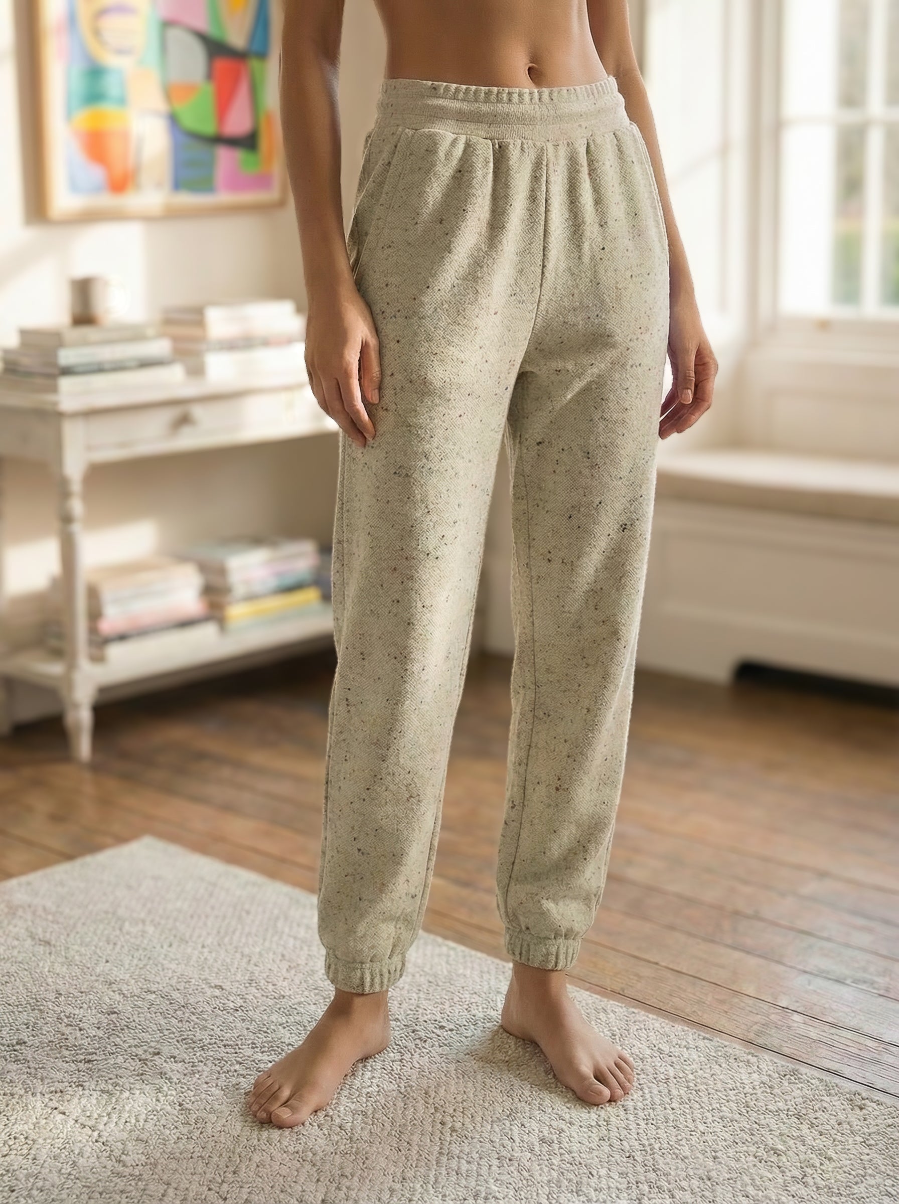 Woman wearing Beige Red Fleck Jogging Pants in a bright living room.