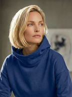 Model wearing Bou Clothing’s Cornfloer luxury hoodie and matching joggers, s in a softly lit modern interior, showcasing a relaxed fit, premium fabric, and minimalist neutral style.