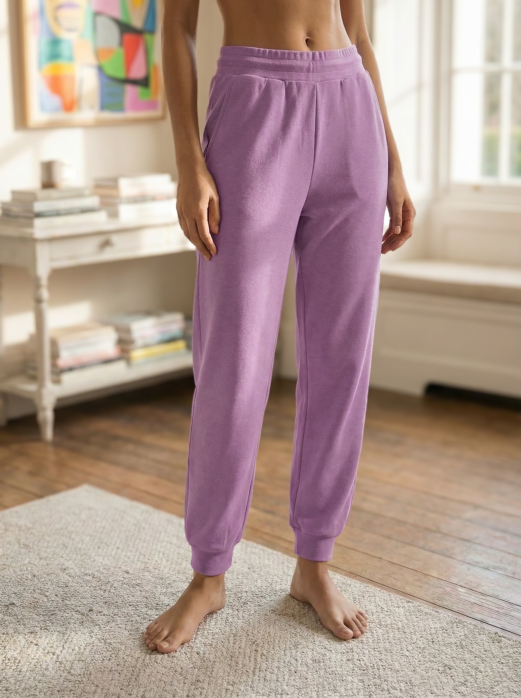 Girl wearing Zibby Sorbet Coloured Joggers/sweatpants in a bright living room.