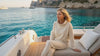 Blonde Woman sitting on a yacht in the wearing a Bou Clothing Cream Deryn Hoodie and Joggers